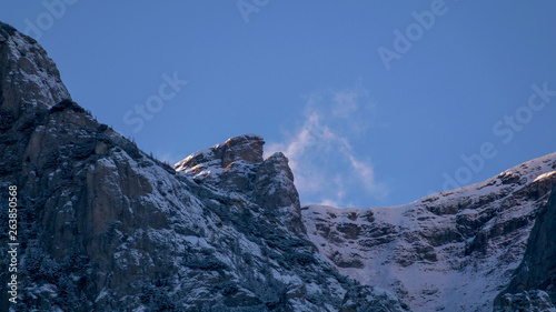 alpine landscape with peaks covered by snow and clouds © vasile