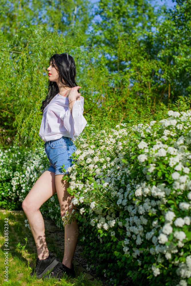 Romantic woman at spring blossom garden. Concept of woman and tenderness, modern beauty or femininity Romantic woman at spring blossom garden. Concept of woman and tenderness, modern beauty or femininity