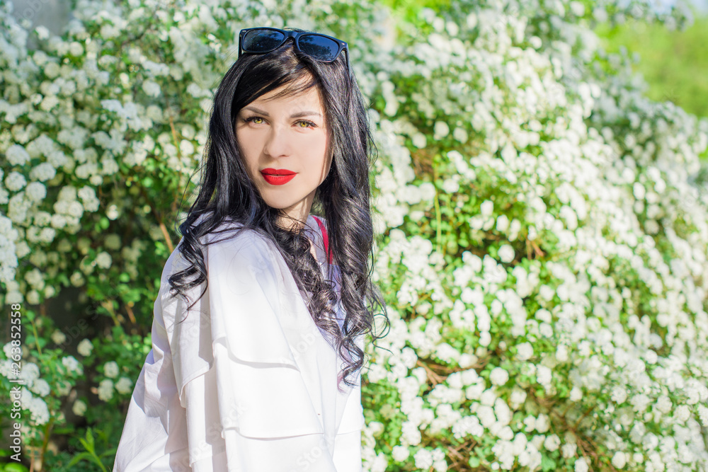 Romantic woman at spring blossom garden. Concept of woman and tenderness, modern beauty or femininity Romantic woman at spring blossom garden. Concept of woman and tenderness, modern beauty or femininity