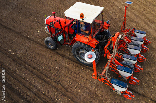 Aerial view of tractor with mounted seeder performing direct seeding