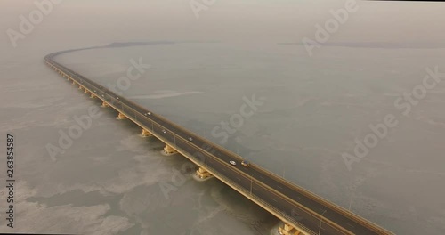 Landscape with a field of ice of the Amur Bay and the bridge Sedanka-De Vries.