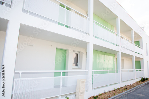 white apartment with green door in new building