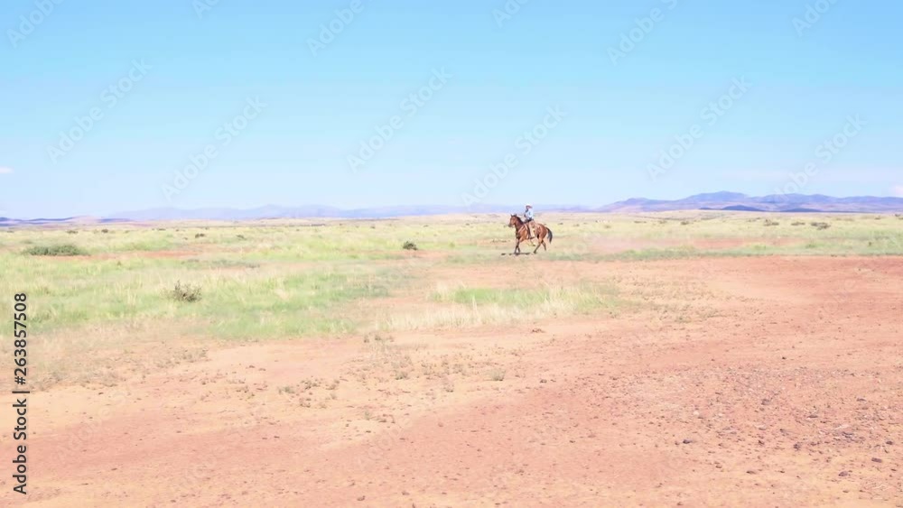 Wide shot of Rancher Riding through Texan plains, Aerial Tracking Shot 4k Wide shot of Rancher Riding through Texan plains, Aerial Tracking Shot 4k