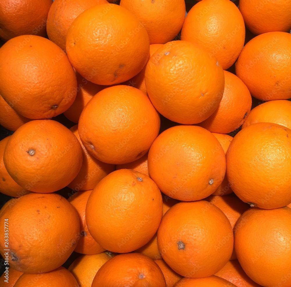 Many oranges on the shelves in the market, the concept of wallpaper background Many oranges on the shelves in the market, the concept of wallpaper background