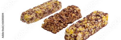 vegan dessert: several cereal bars with raisins and honey, isolated on white, short focus