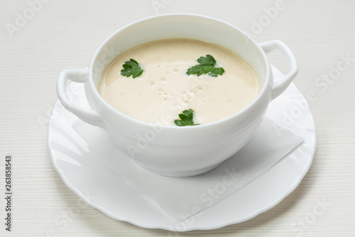 mushroom soup puree, in a plate, decorated with parsley, vegetarian dish