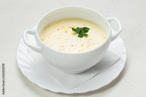 vegetable soup, in a plate, decorated with parsley and dry spices, vegetarian dish