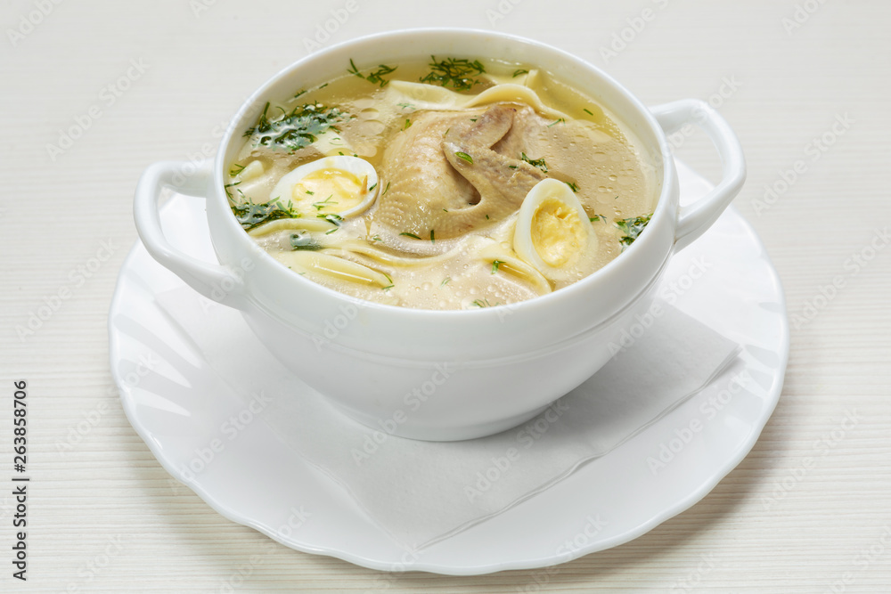 quail soup with noodles and quail eggs in a white plate quail soup with noodles and quail eggs in a white plate