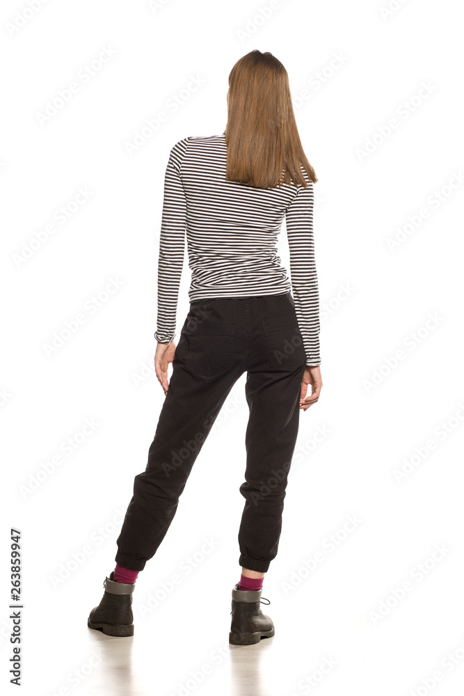 Back view of young woman in blouse posing on white background Back view of young woman in blouse posing on white background