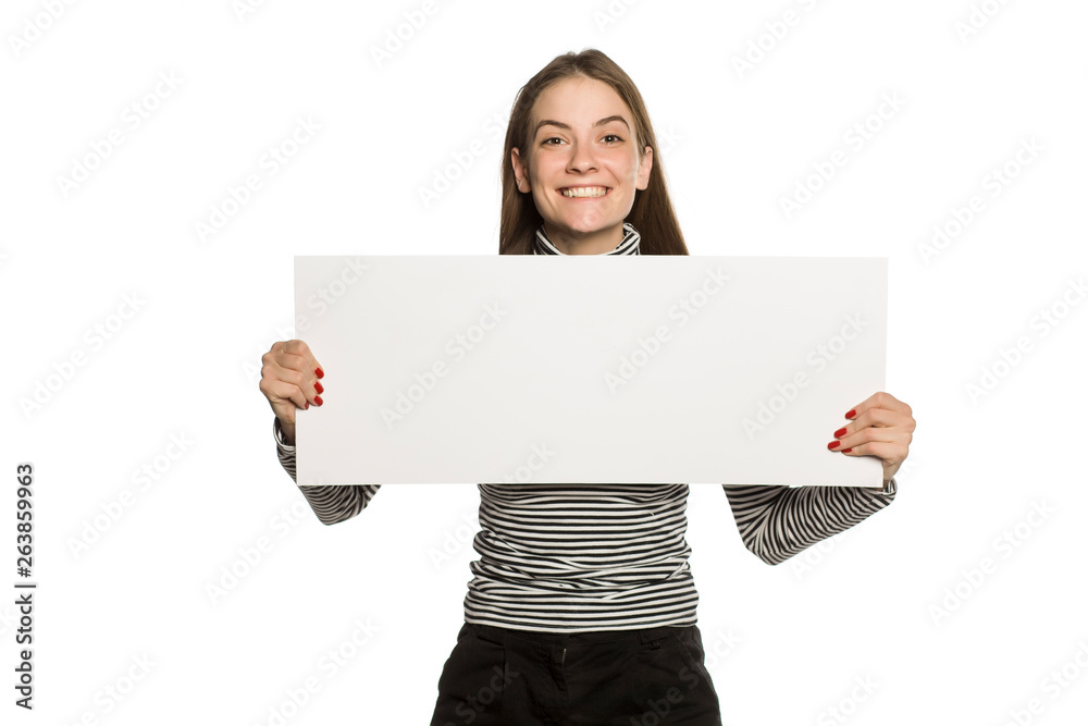 Young model in blouse shows an empty advertising board on white background Young model in blouse shows an empty advertising board on white background