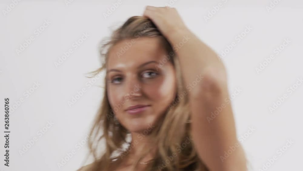Handheld video with a cool glare effect of a beautiful Caucasian model posing and smiling in a red bikini set. Handheld video with a cool glare effect of a beautiful Caucasian model posing and smiling in a red bikini set.