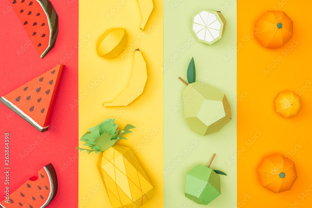 top view of various handmade origami fruits on multicolored paper stripes - obrazy, fototapety, plakaty 