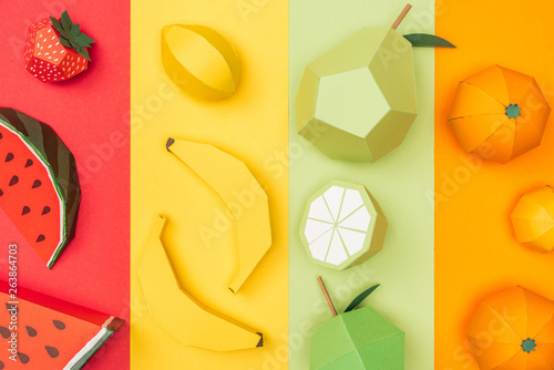 Fototapeta Naklejka Na Ścianę i Meble -  top view of various origami fruits on colorful paper stripes