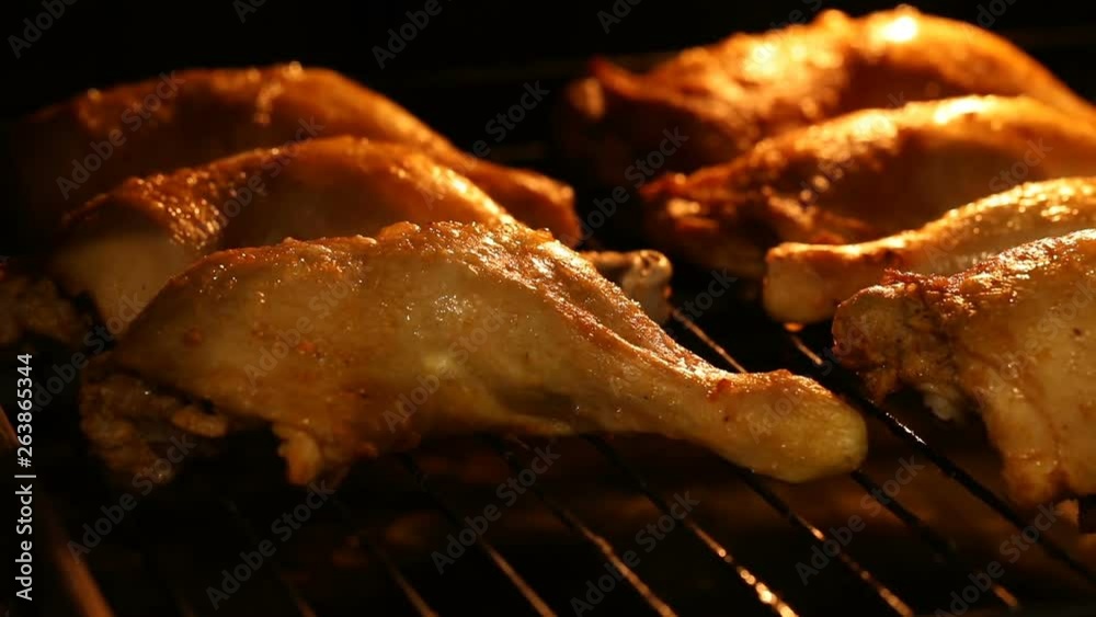 Close-up of baking hot grill chicken legs in the oven with grain processed