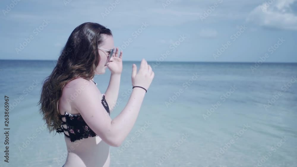 SLOW MOTION: waist up portrait shot of a girl making her way down the coast of Puerto Rico. SLOW MOTION: waist up portrait shot of a girl making her way down the coast of Puerto Rico.