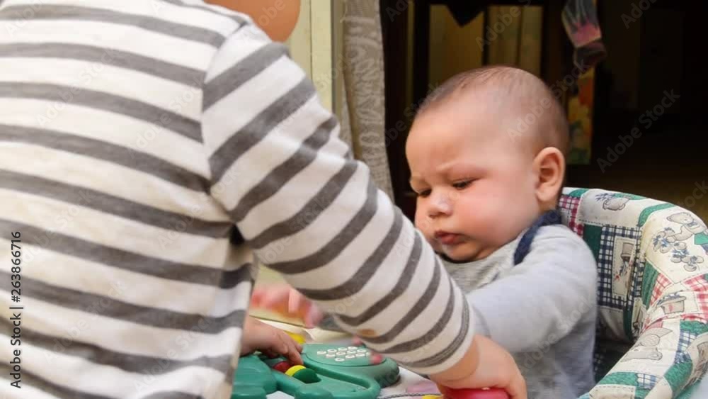 Two cute children from Malta playing together baby boy and toddler Two cute children from Malta playing together baby boy and toddler
