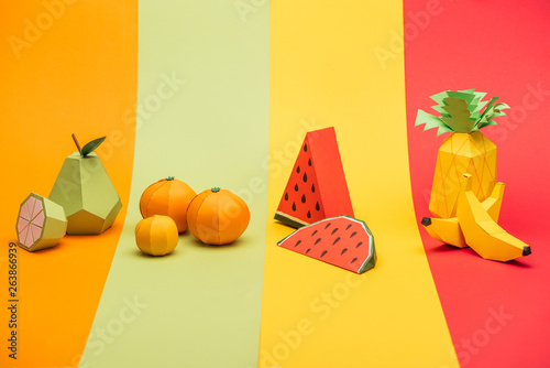 Fototapeta Naklejka Na Ścianę i Meble -  various handmade origami fruits on stripes of colorful paper