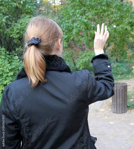 the girl throws rubbish in the bin
