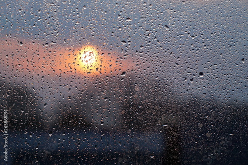 Raindrops on the glass and sunset. Weather forecast.