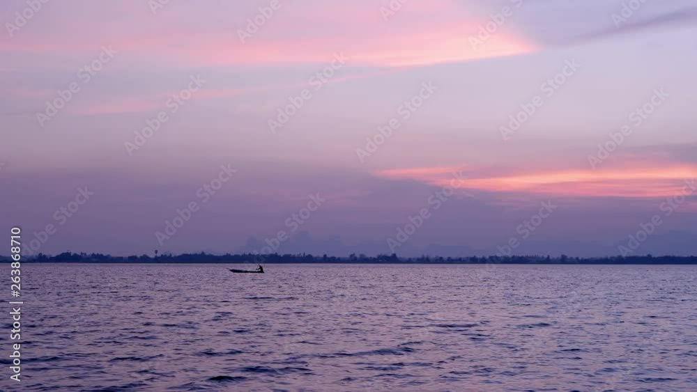 Nature background. Moments after sunset. sky, lake and fishing boat in countryside Nature background. Moments after sunset. sky, lake and fishing boat in countryside