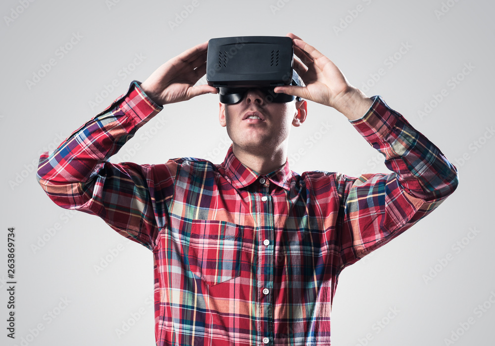 Guy in mask experiencing virtual reality as new entertainment device