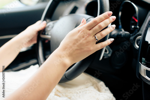 girl s hands on the wheel of a car
