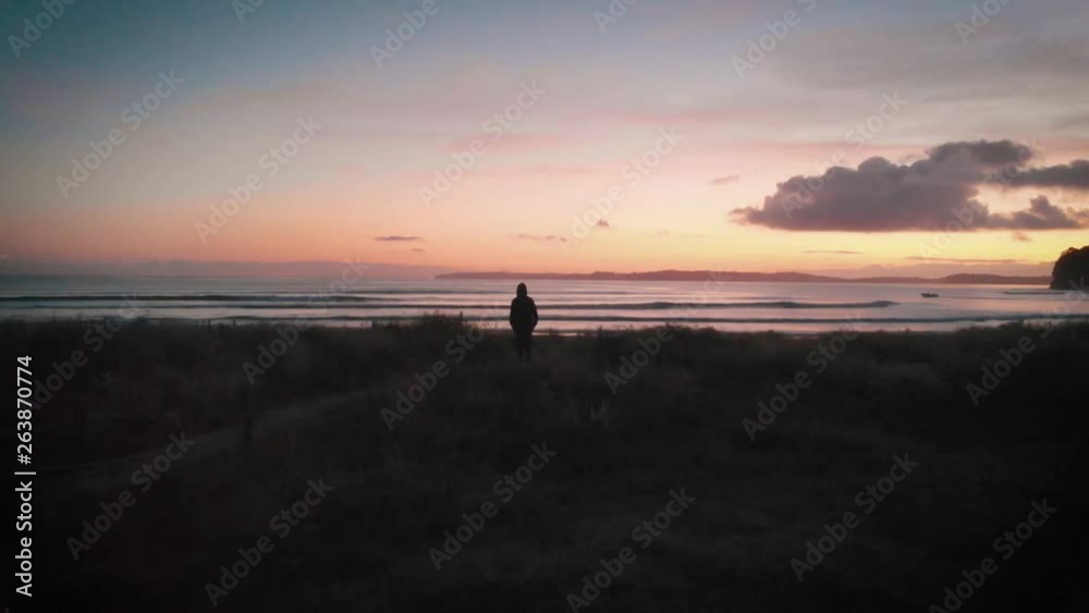 Man looks out towards the South Pacific Ocean in New Zealand Man looks out towards the South Pacific Ocean in New Zealand