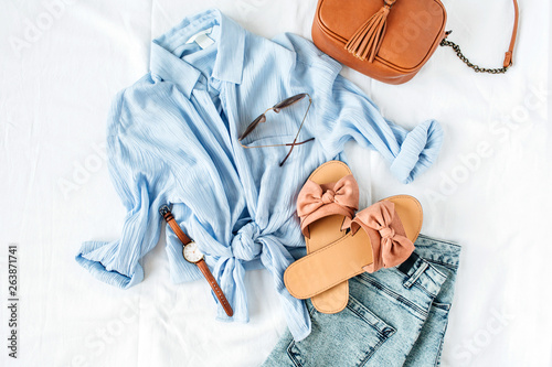 Photographie Feminine summer fashion composition with blouse, slippers, purse, sunglasses, watch, jean shorts on white background