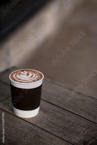hot coffee latte takeaway cup on wood table