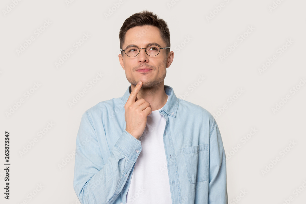 Thoughtful man in glasses isolated on grey background thinking Thoughtful man in glasses isolated on grey background thinking