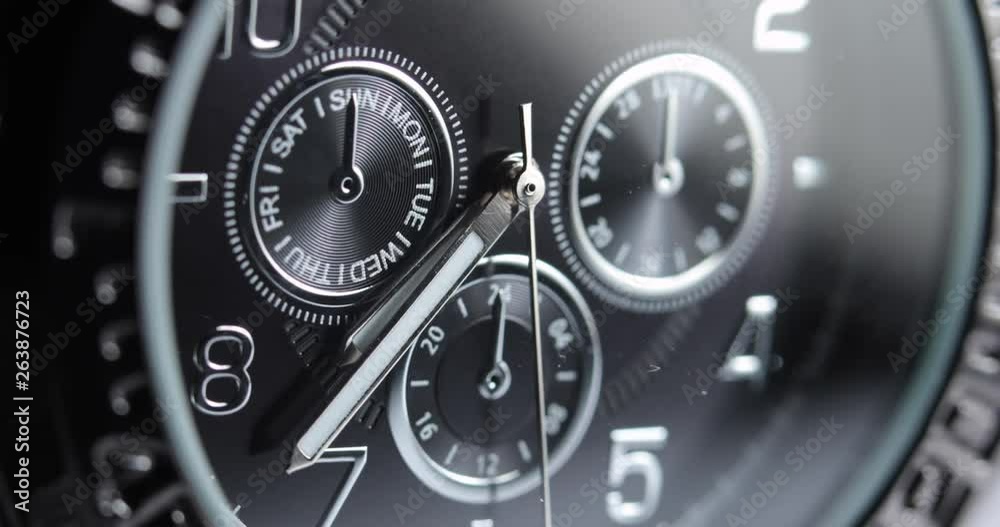 Macro, closeup of a men's silver watch with the time at 7:35. Macro, closeup of a men's silver watch with the time at 7:35.