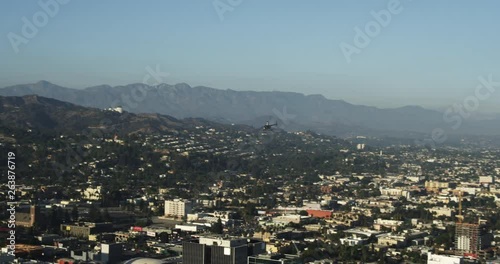 Helicopter soars over Los Angeles, aerial