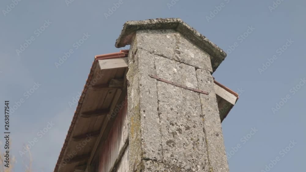 Low angle close up shot of a granary alled espigueiro in a rural village on a hill Friaes Tras-os-Montes Portugal Low angle close up shot of a granary alled espigueiro in a rural village on a hill Friaes Tras-os-Montes Portugal
