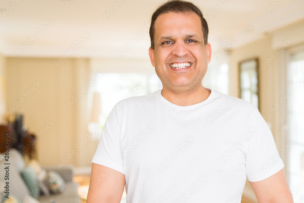 Middle age man smiling confident to the camera at home Middle age man smiling confident to the camera at home