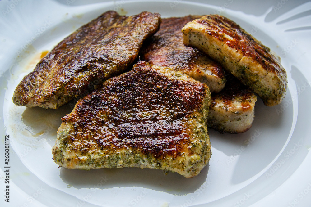 Homemade steak on white plate grilled in spices