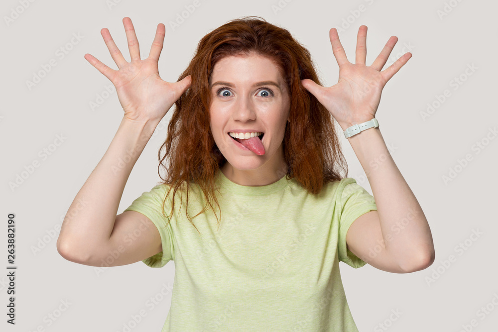 Smiling redhead girl play foolish showing funny faces Smiling redhead girl play foolish showing funny faces
