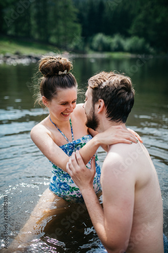 Couple being close to each other swimming