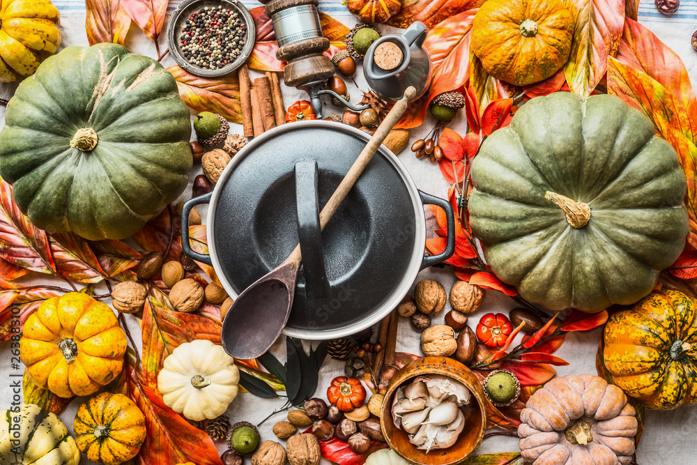 Pumpkins and pot with wooden spoon - obrazy, fototapety, plakaty 