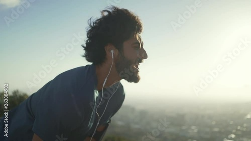 Exhausted sports man taking breath after exercising