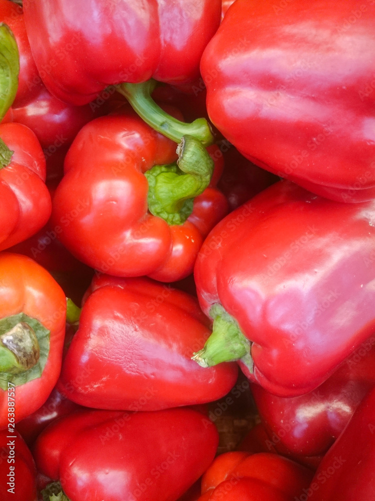 Background cut red sweet pepper in basket bulgarian pepper fresh, assorted colorful capsicum paprika on a counter in the supermarket. Background cut red sweet pepper in basket bulgarian pepper fresh, assorted colorful capsicum paprika on a counter in the supermarket.