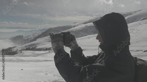 Wallpaper Mural Photographer walking and taking photos in snowy montains. Footage taken with Panasonic Lumix Gh5. Torontodigital.ca