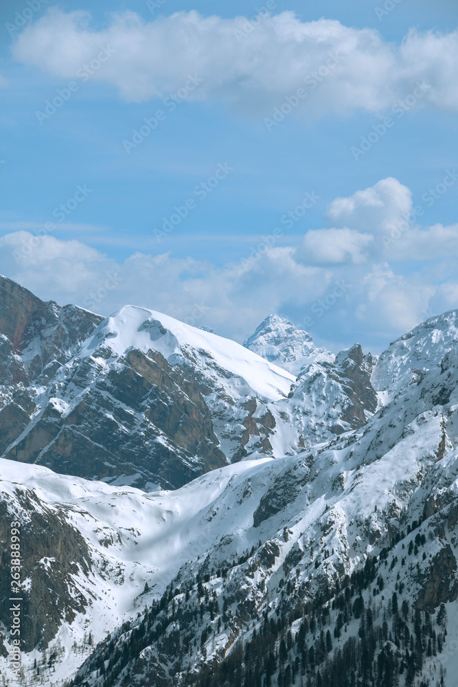 View of mountains in clouds in winter. Alps, Dolomites, Italy.