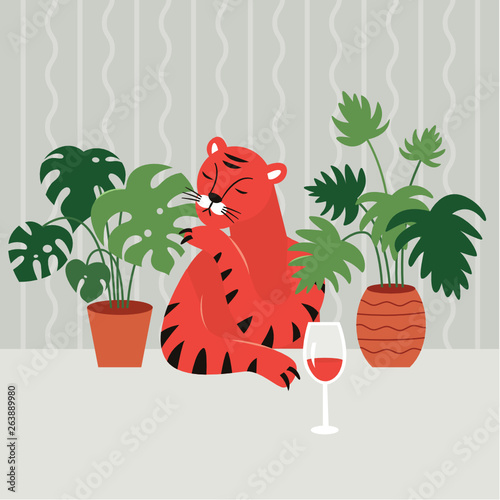 pensive sad tiger at the table drinks red wine