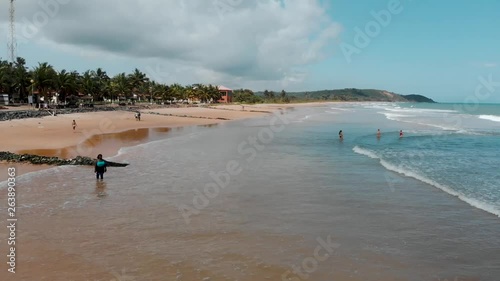 A beautiful drone shot taken at a beach in Ghana, Africa on the western coast. There is a beautiful white sand beach and blue water with some jet skiing happening on a beautiful day at Busua Beach. photo