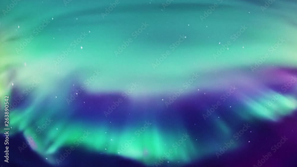 Bright northern lights curtain forming high in the sky.