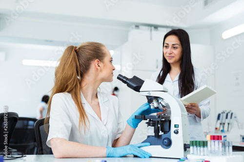 Scientist researcher using microscope in laboratory. Medical healthcare technology and pharmaceutical research and development concept