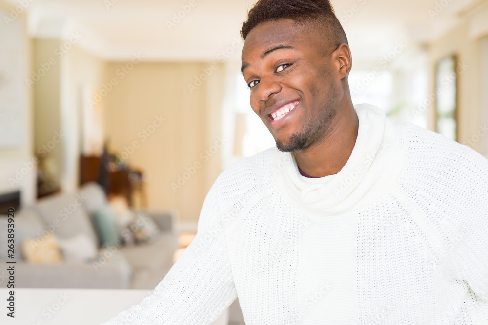 Handsome african young man smiling cheerful with a big smile on face Handsome african young man smiling cheerful with a big smile on face