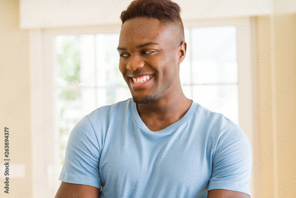 Handsome african young man smiling cheerful with a big smile on face Handsome african young man smiling cheerful with a big smile on face