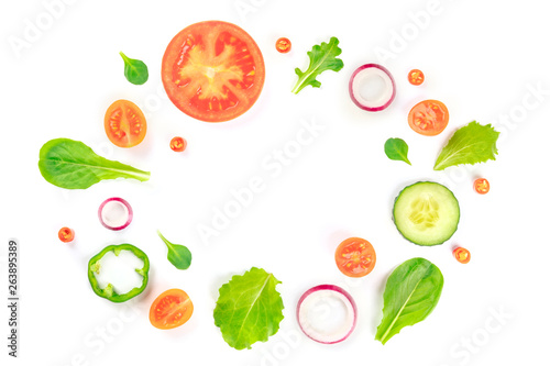 Fototapeta Naklejka Na Ścianę i Meble -  Fresh vegetable salad ingredients, shot from above on a white background. A flat lay composition with tomato, pepper, cucumber, onion slices and mezclun leaves, forming a frame with a place for text