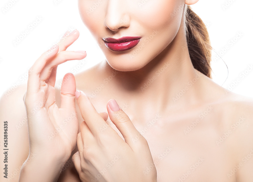 Bright red glossy lips, hand near face, neck and shoulder of young model woman. Perfect skin, bright make-up. White background Bright red glossy lips, hand near face, neck and shoulder of young model woman. Perfect skin, bright make-up. White background